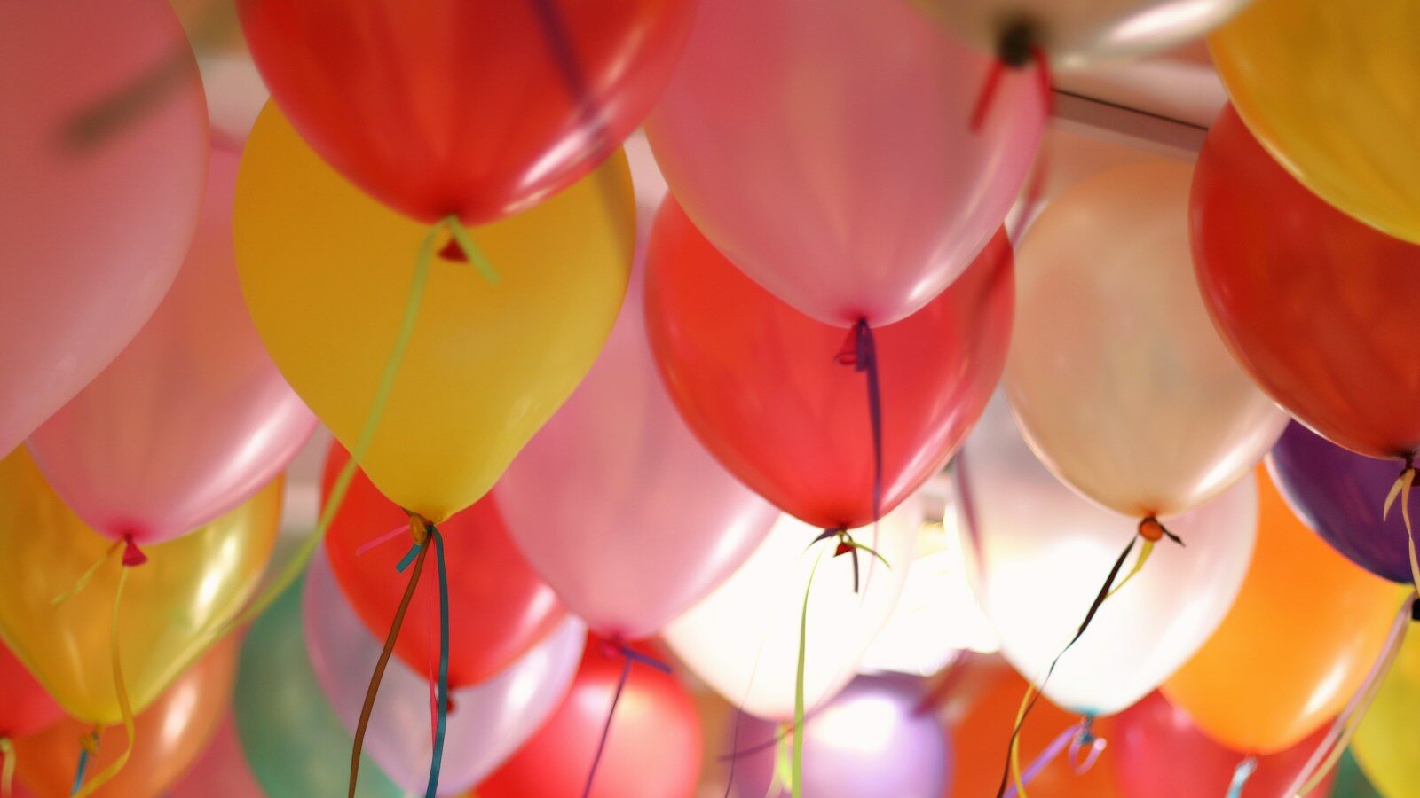 pink and yellow balloons in close up photography